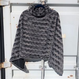 Luxuriously soft faux fur SLEEVELESS, reversible poncho in grey.